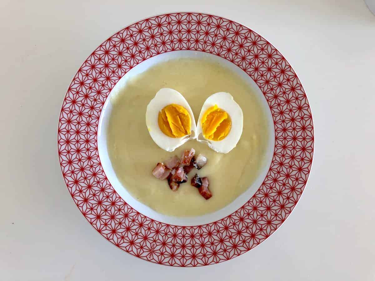 Polish Horseradish Soup Recipe topped with eggs and bacon.