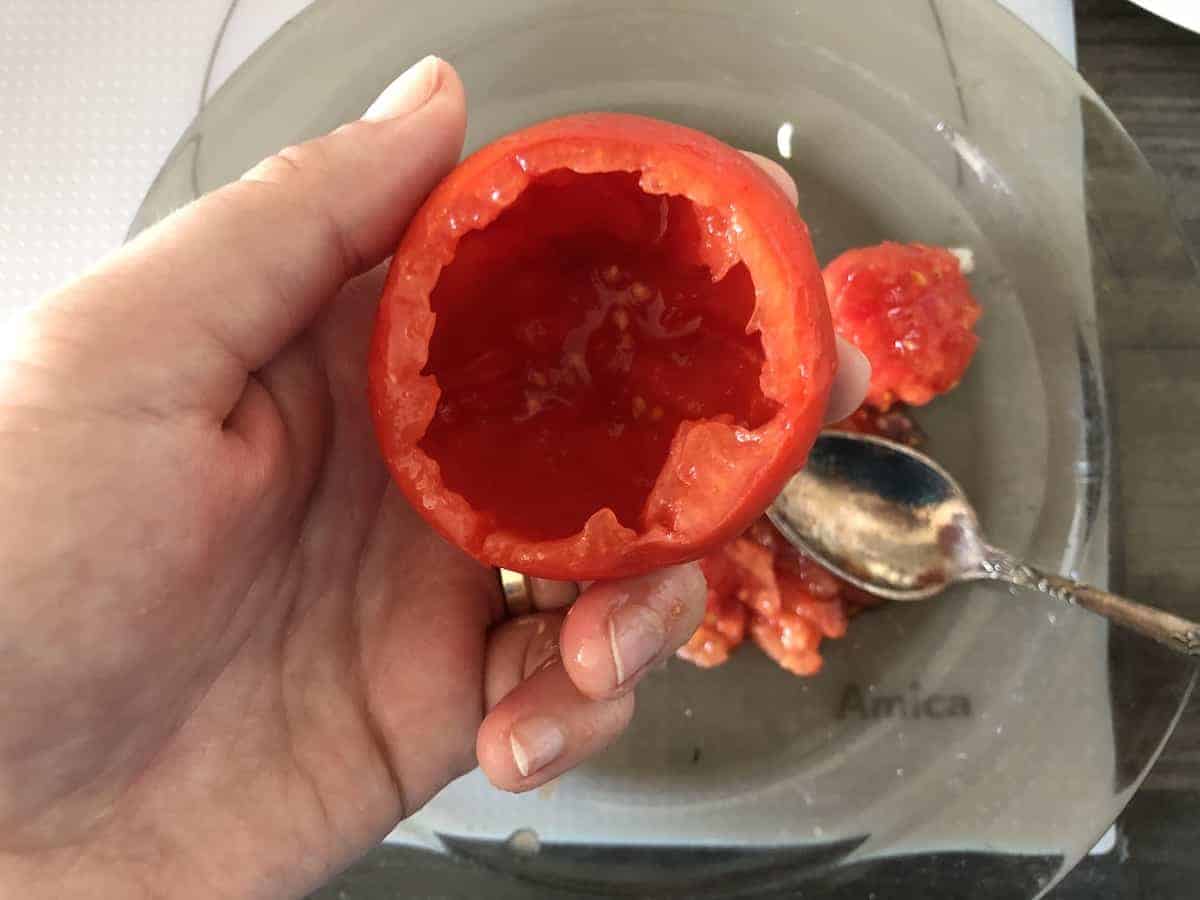 A person showcasing a Polish stuffed tomato recipe.