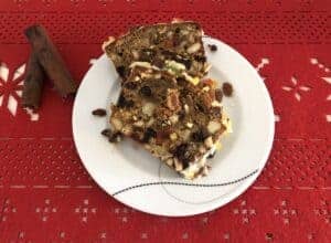 A slice of Polish fruitcake with cinnamon sticks.