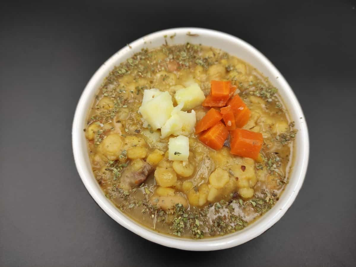 Grochowka soup in a white bowl.