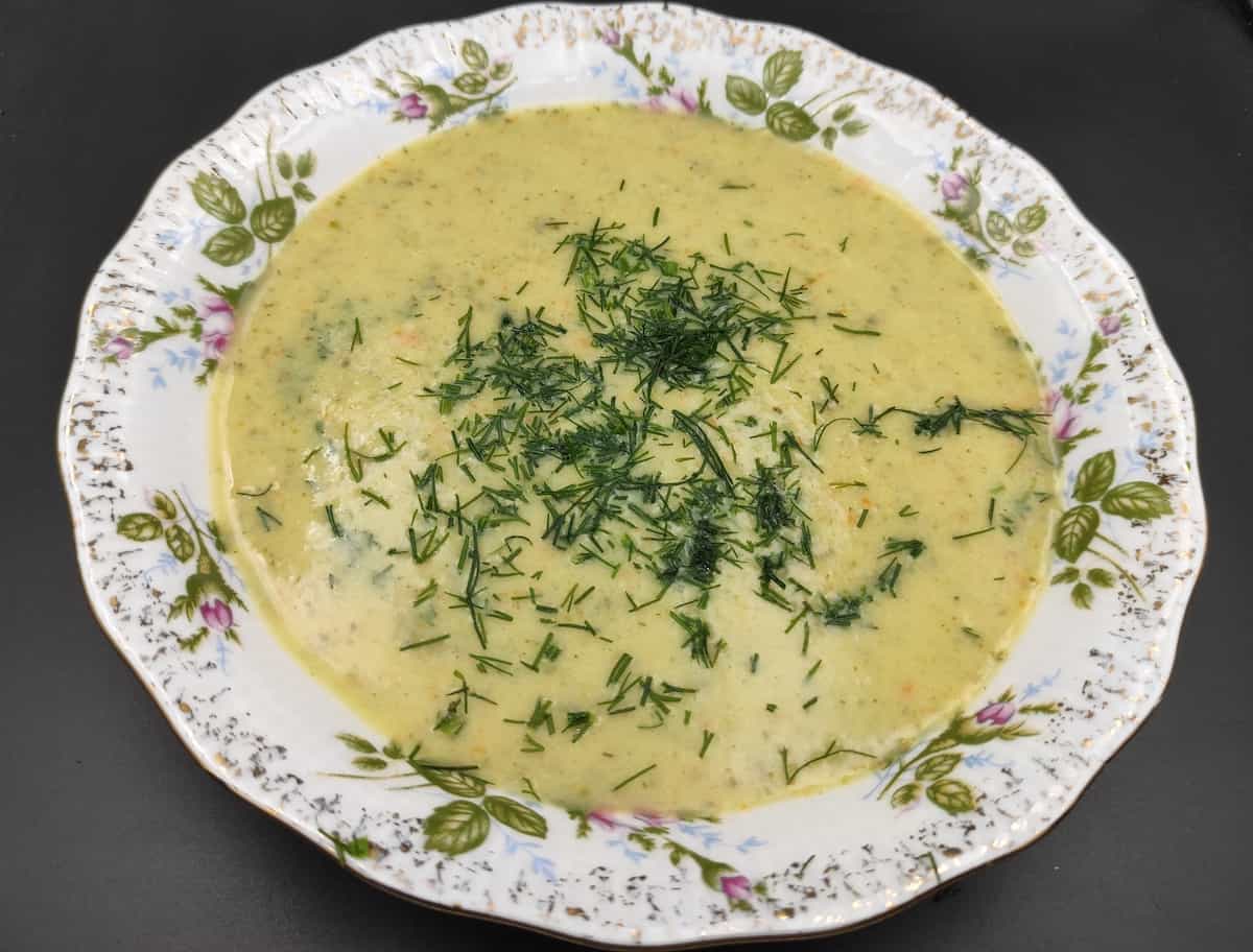 zupa z ogórków fresh cucumber soup in a white bowl.