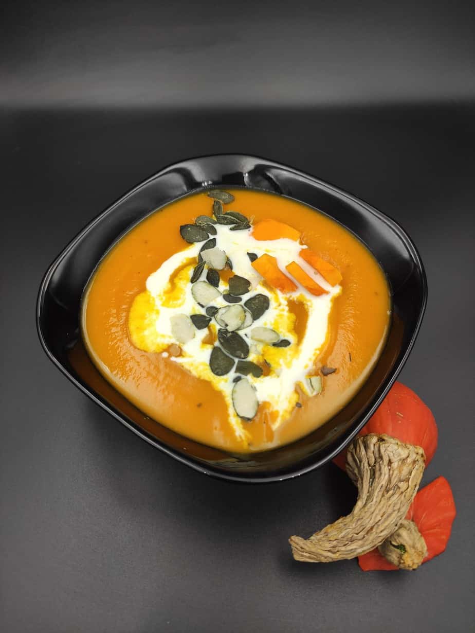 Pumpkin soup with cream and pumpkin seeds.