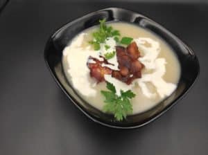 A winter white soup with bacon and parsley.