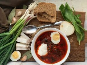 Red borscht soup with eggs and leeks.