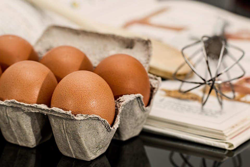 eggs next to a cookbook.