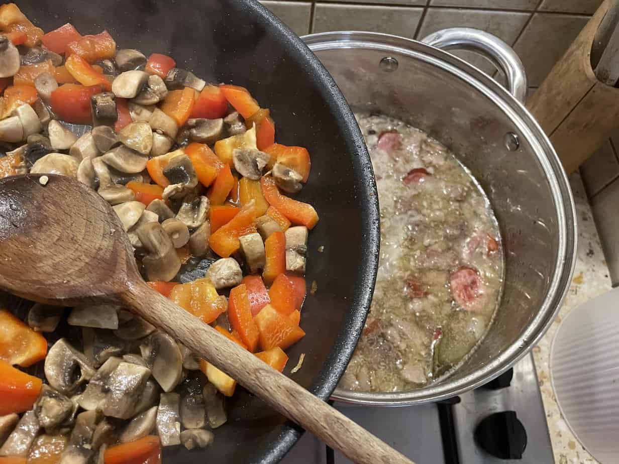 A pan full of mushrooms and vegetables cooking on a stove, along with a traditional Polish meat stew recipe called forszmak Lubelski.