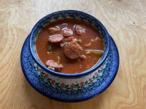 A bowl of Forszmak Lubelski, a traditional Polish Meat Stew, placed on a rustic wooden table.