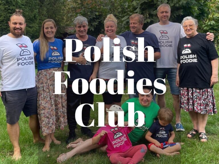 A group of people wearing "Polish Foodie" shirts, celebrating their love for Polish cuisine, stand together outdoors, smiling for the camera.