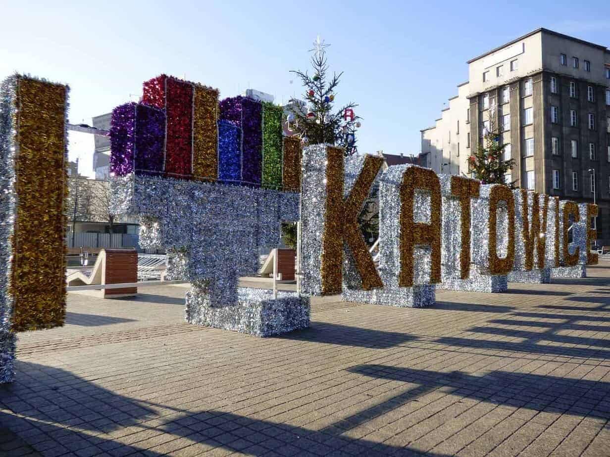 Large decorative letters spell out "I ♥ KATOWICE" in a public square in Slaskie, Poland, with tinsel-covered letters and buildings in the background—a favorite spot among the best attractions and places to visit in the city.
