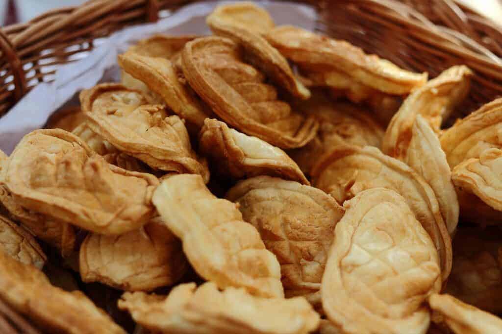 A basket filled with several pieces of golden-brown, fish-shaped pastries, a delightful treat you might find while exploring things to do in Zakopane, Poland.