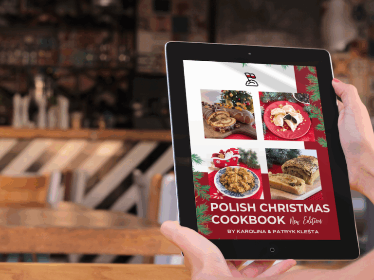 A person holds a tablet displaying the cover of "Polish Christmas Cookbook"—featuring festive dishes, holiday decorations, and authors Karolina & Patryk Klesta—perfect inspiration for your Christmas Kit.